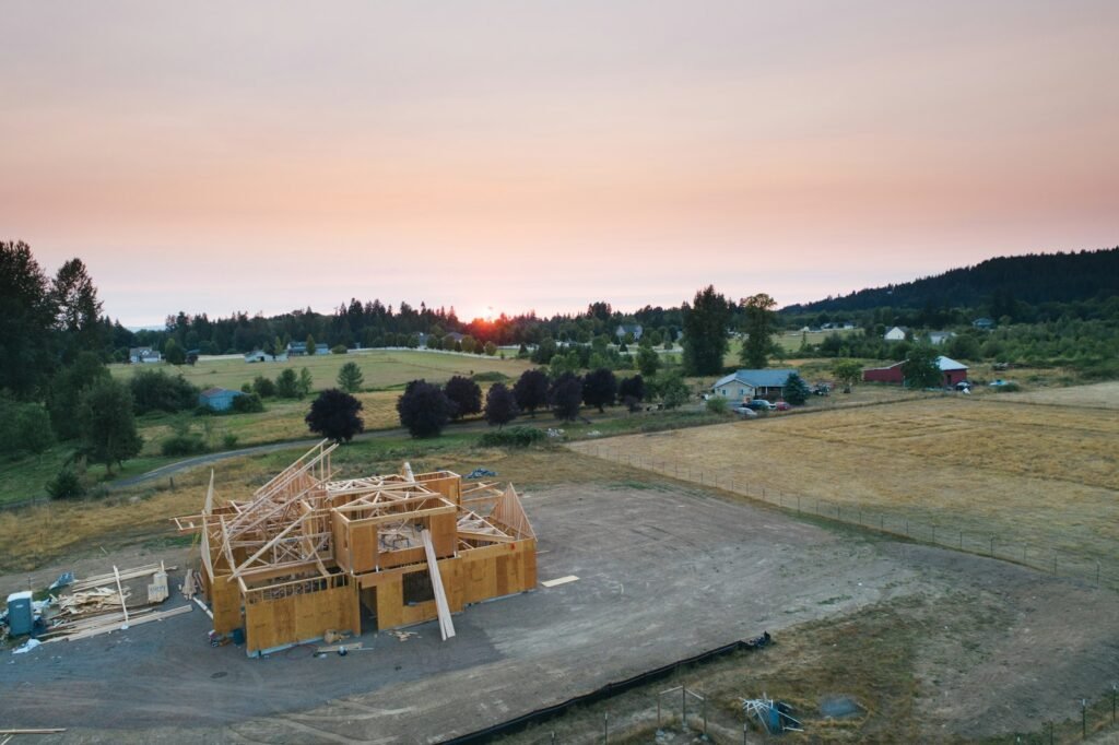 A small modern wooden cottage against an open landscape