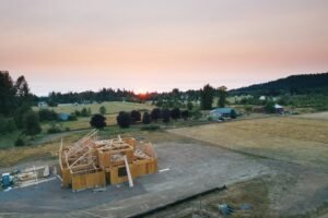 A small modern wooden cottage against an open landscape