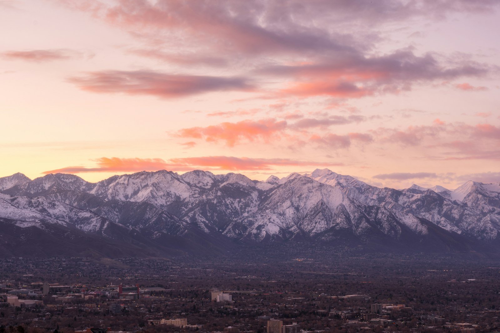 Snow-covered Utah mountains under a soft cloudy sky
